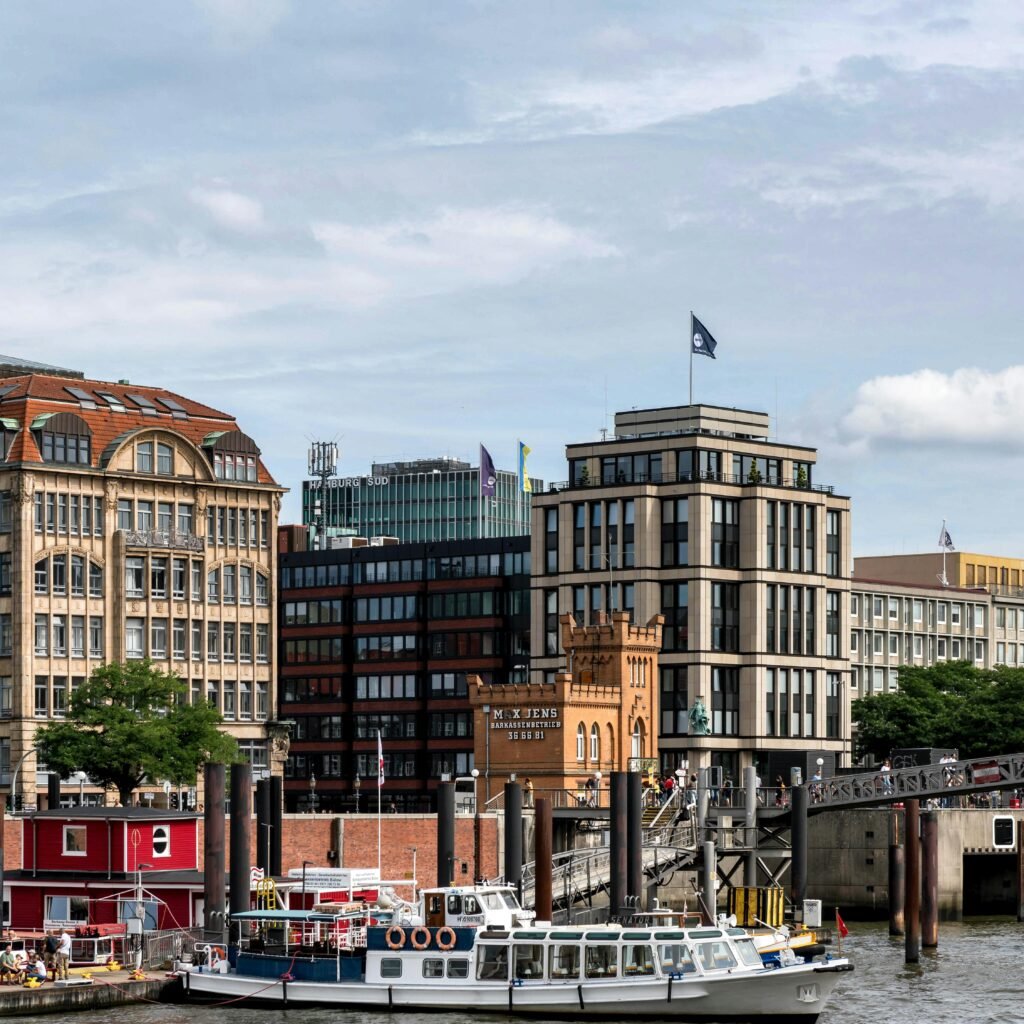 Panoramic view of Hamburg's iconic skyline and harbor with boats.
